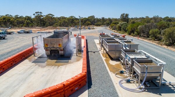 Closed-loop washbay system treating construction tool wash water