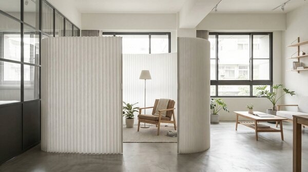 Foldable paper divider creating flexible room separation in interior space